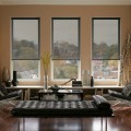 beautiful-black-roller-window-blinds-remodel-for-minimalist-apartment-living-room-with-laminated-floors-and-black-chairs