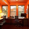 cool-home-office-design-for-two-people-with-gray-windows-blinds-wooden-ceiling-panels-gray-office-table-with-chairs-orange-wall-table-lamp-wooden-floor-globe-hanging-bulb-lam